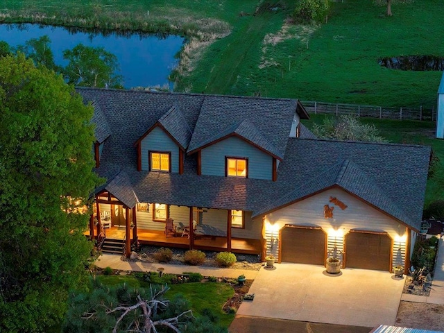 6167 24th St SW, Pine River, MN 56474 - view of front of house with a shingled roof, an attached garage, concrete driveway, and a water view