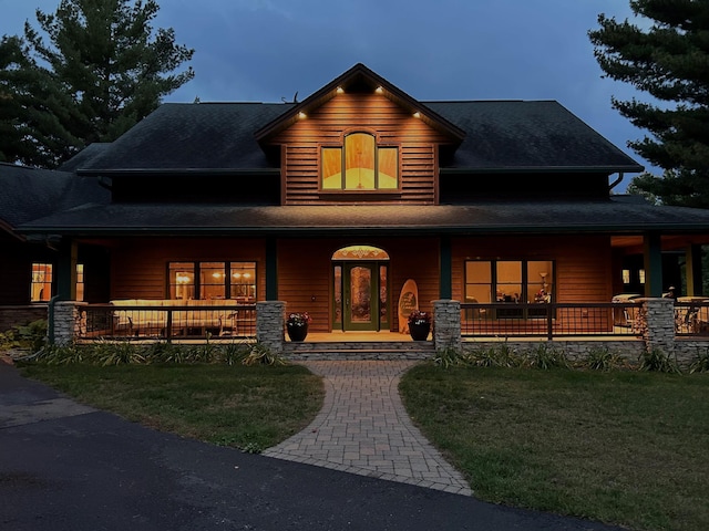 view of front of home featuring a front yard and covered porch