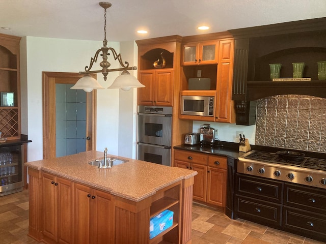 kitchen with open shelves, appliances with stainless steel finishes, a kitchen island with sink, a sink, and beverage cooler