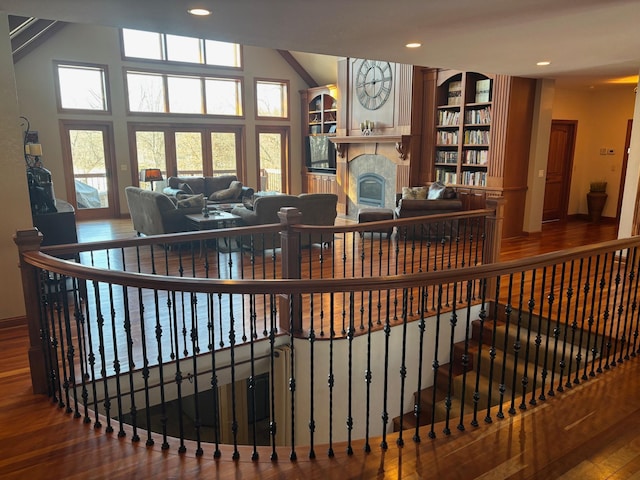 interior space with a fireplace, wood finished floors, and recessed lighting