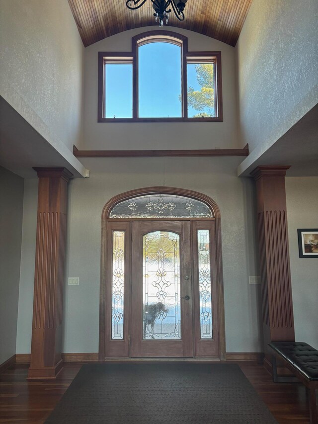 entryway with baseboards, ornate columns, and wood finished floors