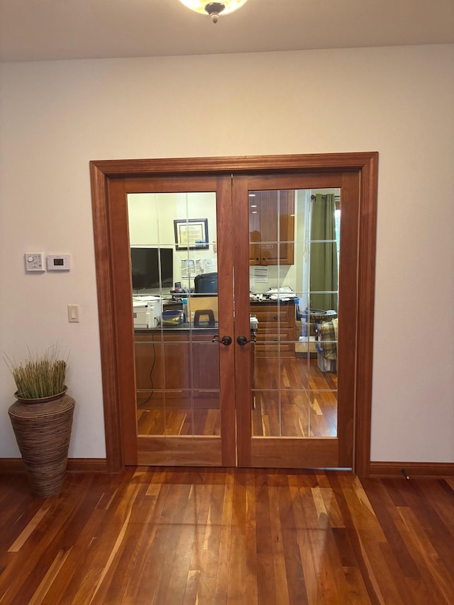 doorway to outside featuring french doors, baseboards, and hardwood / wood-style flooring