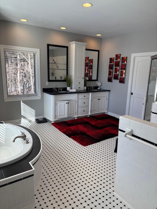 full bathroom featuring recessed lighting, vanity, baseboards, a shower, and a bath