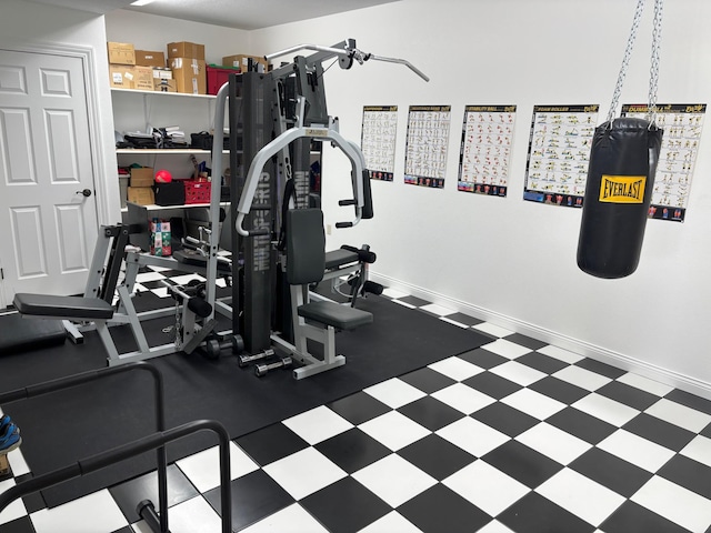 workout room with baseboards and tile patterned floors