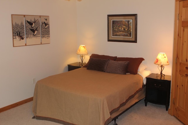 carpeted bedroom featuring baseboards