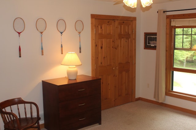 bedroom featuring light colored carpet and baseboards