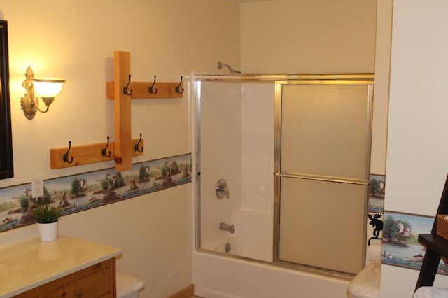 bathroom with toilet, shower / bath combination with glass door, and vanity