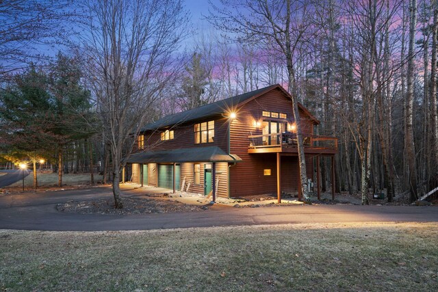 7251 County Rd B, Siren Twp, WI 54872 - chalet / cabin with an attached garage, driveway, and a balcony