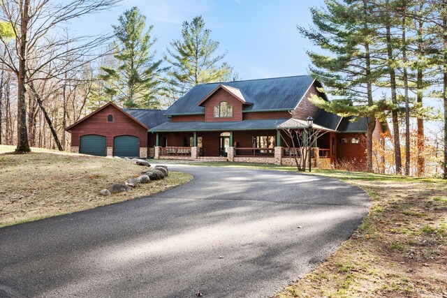 7251 County Rd B, Siren Twp, WI 54872 - view of front of home with an attached garage, driveway, a porch, and stone siding