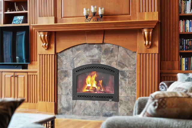7251 County Rd B, Siren Twp, WI 54872 - interior details with built in shelves, wood finished floors, and a tiled fireplace