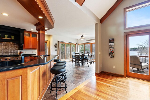 7251 County Rd B, Siren Twp, WI 54872 - kitchen with recessed lighting, a breakfast bar, dark countertops, a ceiling fan, and baseboards