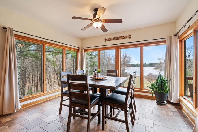 7251 County Rd B, Siren Twp, WI 54872 - dining space featuring stone tile flooring, a water view, and ceiling fan