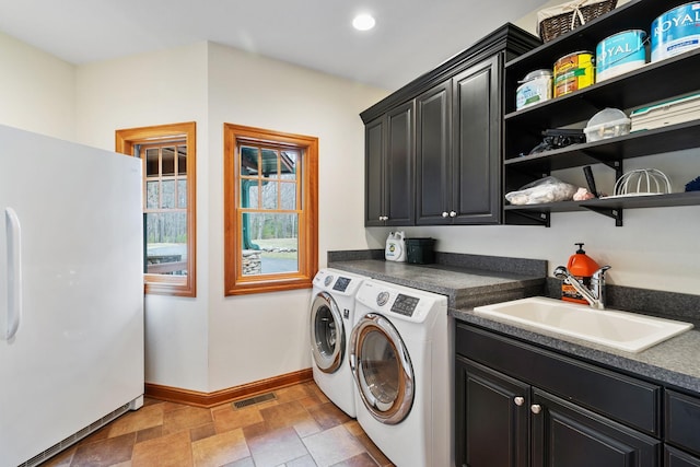 7251 County Rd B, Siren Twp, WI 54872 - clothes washing area featuring a sink, washing machine and dryer, baseboards, visible vents, and cabinet space
