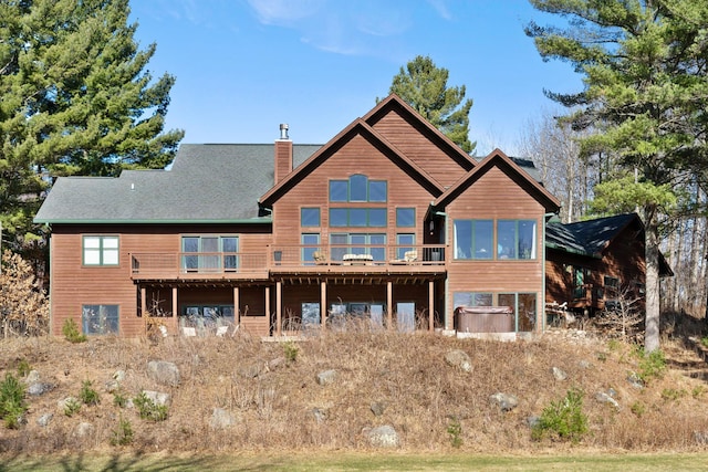 7251 County Rd B, Siren Twp, WI 54872 - rear view of property featuring a wooden deck and a chimney