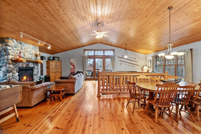 7251 County Rd B, Siren Twp, WI 54872 - dining room featuring lofted ceiling, wooden ceiling, a stone fireplace, and rail lighting