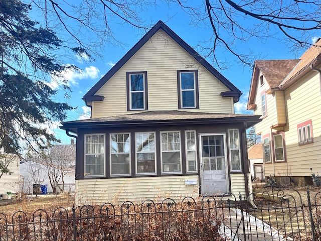 view of front of property with entry steps and a fenced front yard