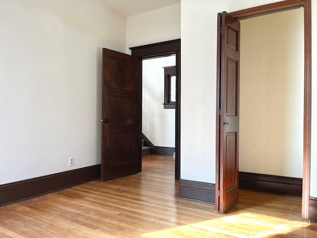 unfurnished bedroom with baseboards and light wood finished floors