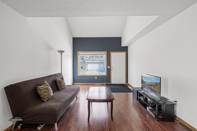 living area with baseboards, wood finished floors, and vaulted ceiling