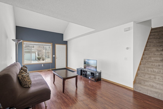 living room featuring baseboards, stairs, lofted ceiling, and wood finished floors