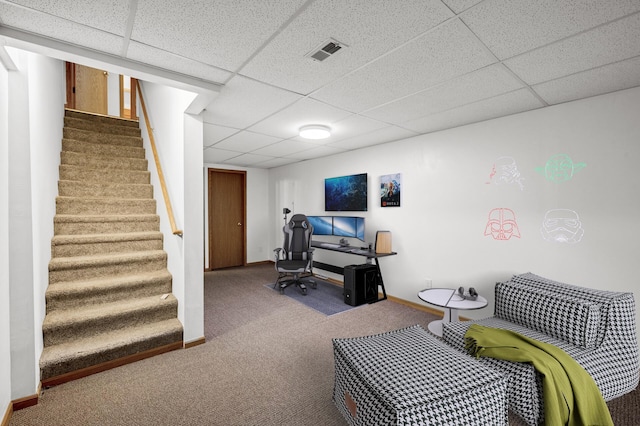 living area with visible vents, a paneled ceiling, and carpet flooring