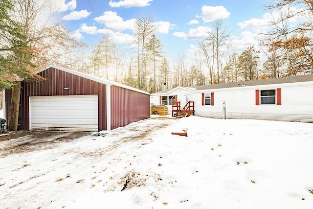 exterior space featuring a garage and an outdoor structure