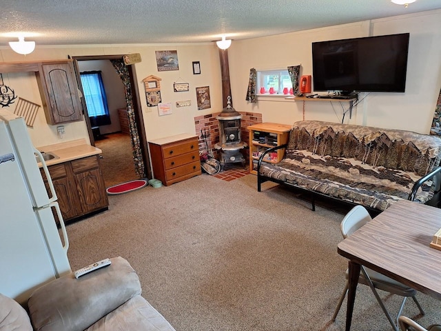 carpeted living room with ornamental molding, plenty of natural light, and a textured ceiling