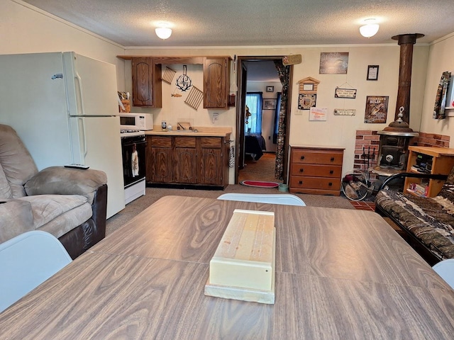 interior space with ornamental molding, a textured ceiling, and light colored carpet