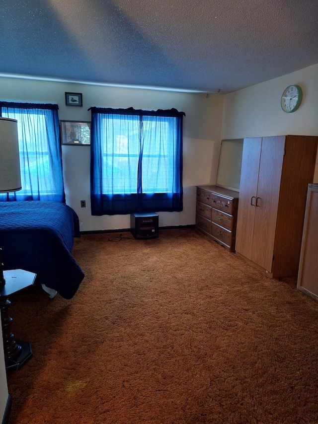 carpeted bedroom featuring a textured ceiling