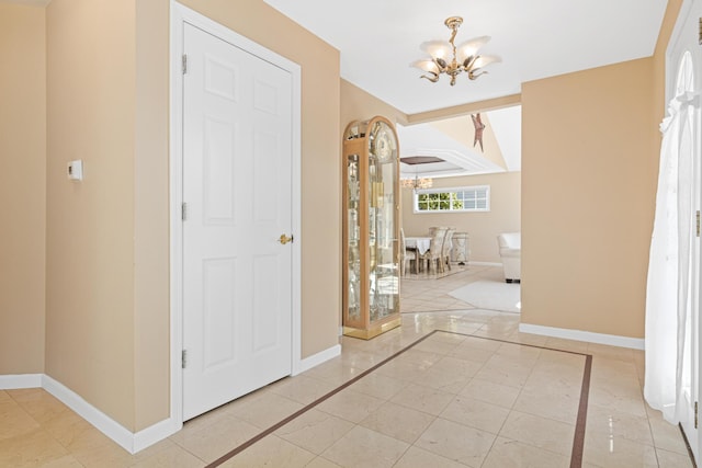 interior space with baseboards and an inviting chandelier