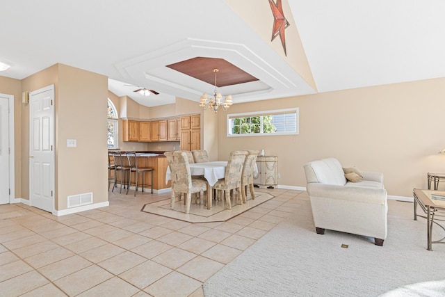 dining space with visible vents, baseboards, an inviting chandelier, light tile patterned floors, and a raised ceiling