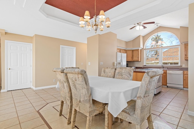 dining area with baseboards, a raised ceiling, light tile patterned flooring, and ceiling fan with notable chandelier