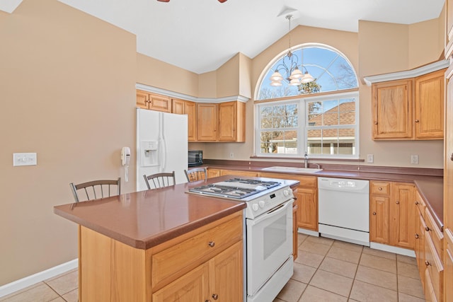 kitchen with a center island, light tile patterned floors, ceiling fan with notable chandelier, white appliances, and a sink