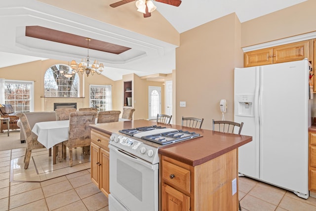 kitchen featuring white appliances, a fireplace, open floor plan, and a wealth of natural light