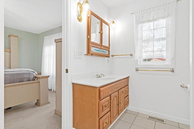 bathroom with vanity, baseboards, visible vents, tile patterned flooring, and connected bathroom