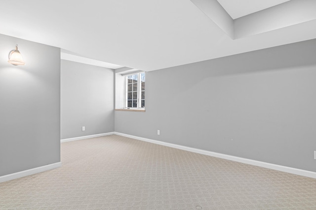 carpeted empty room with baseboards