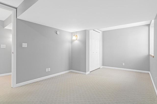 unfurnished room with baseboards and carpet floors