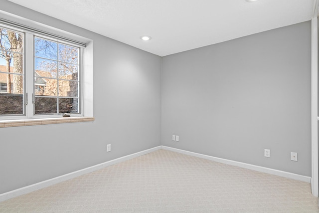 carpeted empty room featuring recessed lighting and baseboards