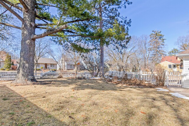 view of yard with a residential view and a fenced front yard