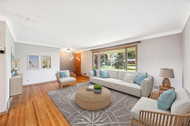 living room with light wood-style flooring and baseboards