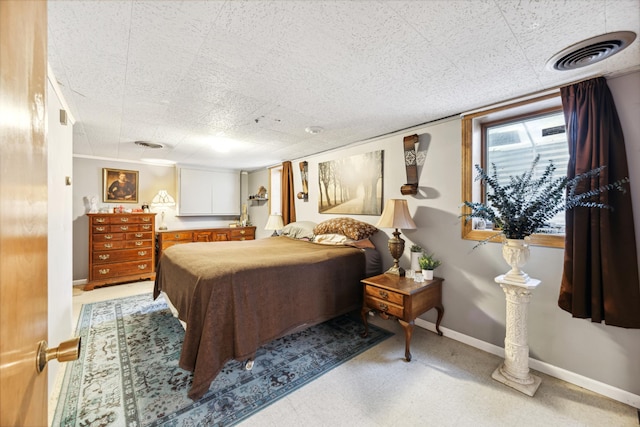 bedroom with visible vents and baseboards