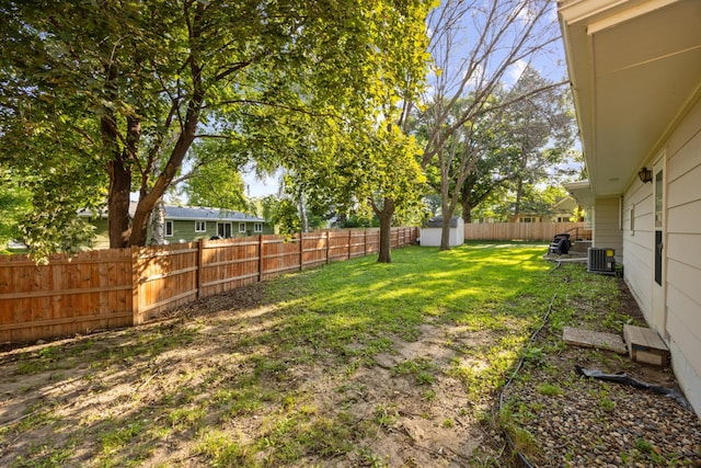 view of yard featuring a fenced backyard and central air condition unit