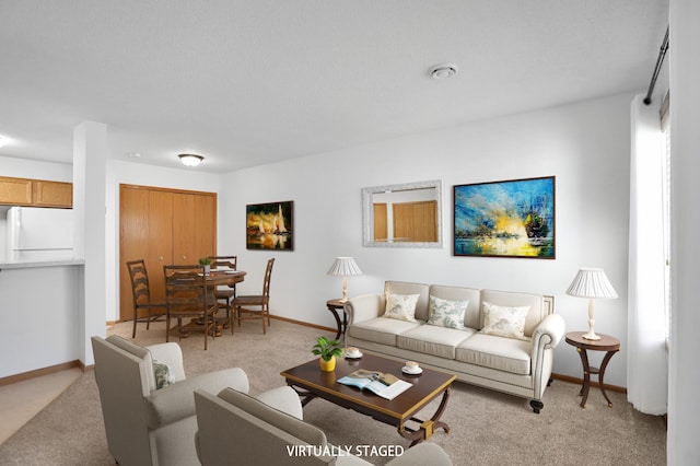 living room featuring baseboards and light colored carpet