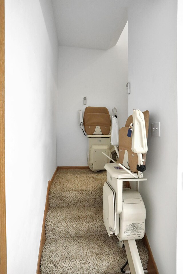stairway featuring baseboards