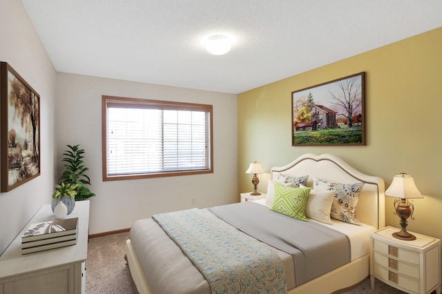 carpeted bedroom with a textured ceiling and baseboards