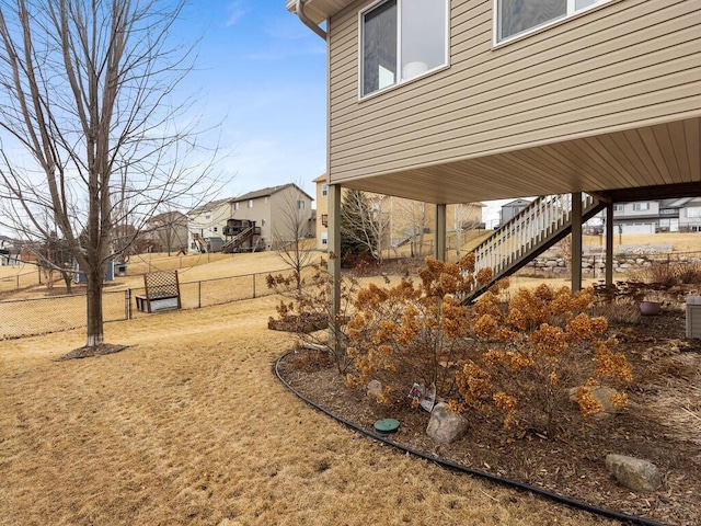 view of yard featuring stairs and fence