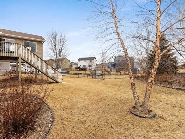 view of yard with stairway, fence, and a wooden deck