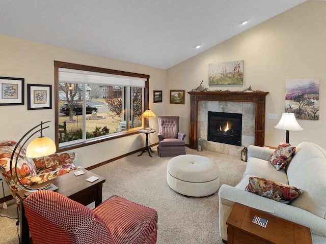 carpeted living area featuring lofted ceiling, a tiled fireplace, and baseboards