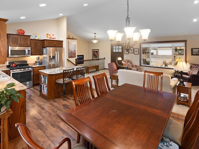 dining area with an inviting chandelier, high vaulted ceiling, dark wood-type flooring, and recessed lighting