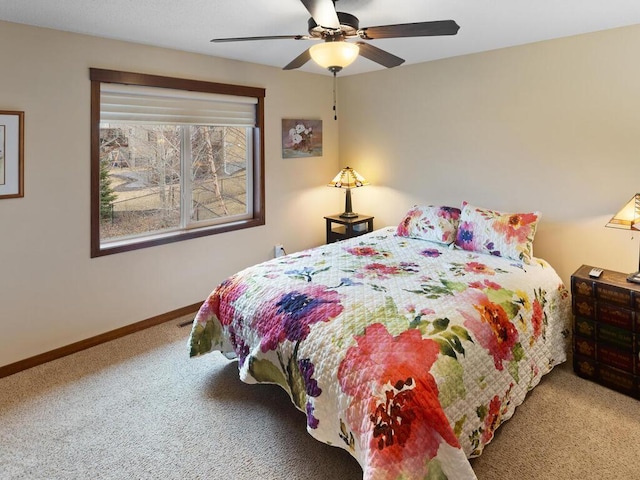 carpeted bedroom featuring a ceiling fan and baseboards