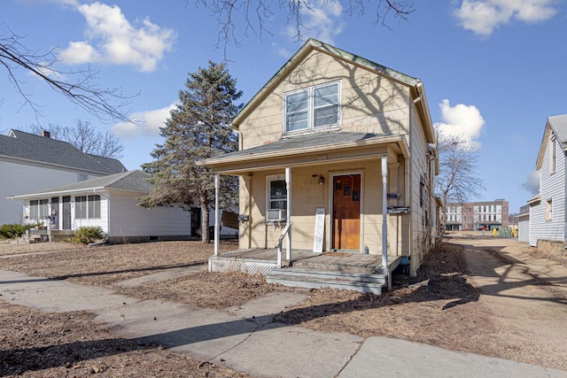 view of front of property with a porch and cooling unit